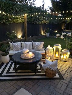 an outdoor living room is decorated with candles