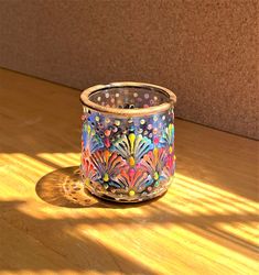 a glass vase sitting on top of a wooden table