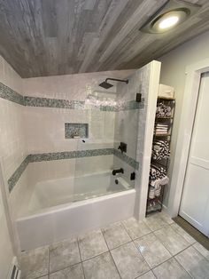 a bath tub sitting next to a walk in shower