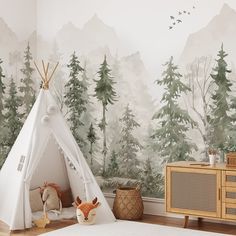 a child's room with a teepee tent and forest wallpaper