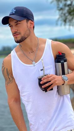 a man holding a coffee cup and water bottle