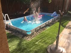 two children playing in an above ground pool