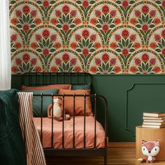 a bedroom with green walls and floral wallpaper in the corner, along with a small bed