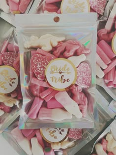 some pink and white cookies in a clear plastic bag with gold foil lettering on it