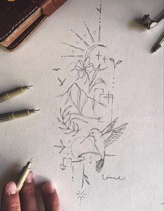 a person holding a pen in their hand next to a drawing on paper with ink