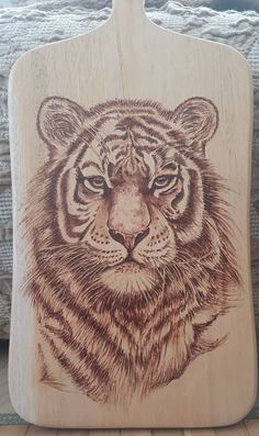 a wooden cutting board with an image of a tiger on it