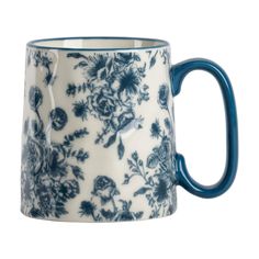 a blue and white coffee mug with flowers on the inside is sitting in front of a white background