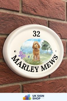 a sign on the side of a brick wall that says 32 marley mews