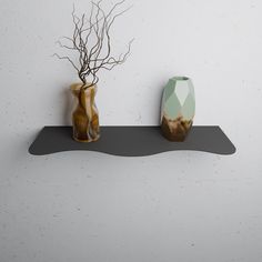 two vases sitting on top of a shelf next to each other with branches in them