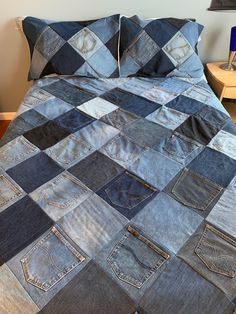 a bed that has some blue jeans on it