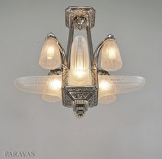 an art deco chandelier with frosted glass shades