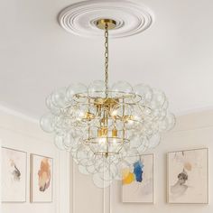 a chandelier hanging from the ceiling in a living room