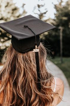 a woman with long hair wearing a graduation cap