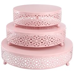 three pink cake stands stacked on top of each other with hearts cut out the sides