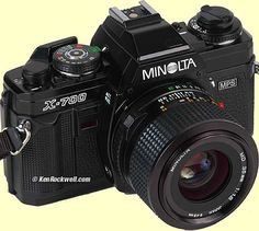 a black camera with a lens attached to it's body and the words minolta on the front