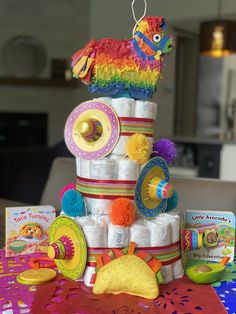 a stack of diapers sitting on top of a table next to toys and books