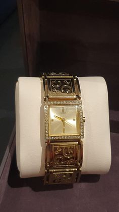 Guess Quartz Dress Ladies' Watch is featuring a champagne coloured Dial,  adorned with golden hands & baton hour markers  framed by a row of crystals S/Steel gold-plated rectangle Case is measuring 22mm x 27mm,  signed & numbered at the back  Sturdy S/Steel & gold-plated Bracelet that would fit 19.5cm wrist  Quartz Japan Movement  (with new battery) In great condition Gold Diamond Watch With Metal Dial For Evening, Gold Diamond Watch With Rectangular Dial, Gold Rectangular Analog Watch, Rectangular Gold Analog Watch, Gold Analog Watch With Rectangular Face, Gold Rectangular Analog Jewelry And Watches, Gold Diamond Watch With Rectangular Case, Gold Diamond Watch With Rectangular Shape, Gold Diamond Watch With Rectangular Face