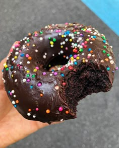 a half eaten chocolate doughnut with sprinkles