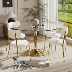 a glass table with white chairs and a cat laying on the floor in front of it