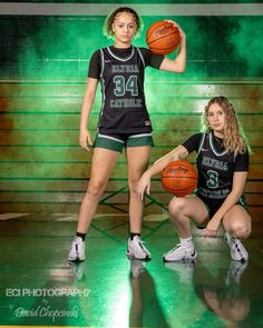 two girls in black and green uniforms holding basketballs