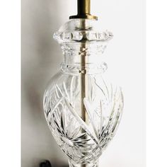 a clear glass lamp with a gold base