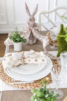 the table is set with plates, napkins and place settings for an easter dinner