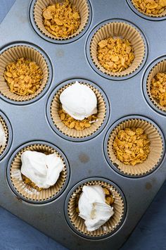 cupcakes with white frosting in muffin tins