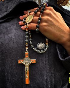 a close up of a person holding a rosary