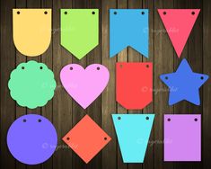 colorful paper tags hanging from clothes pins on a wooden background with clippings to cut out the shapes