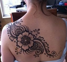 a woman with a tattoo on her back