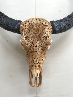 an animal's skull is adorned with intricate carvings