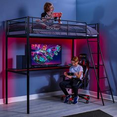 two children are playing video games on their bunk beds