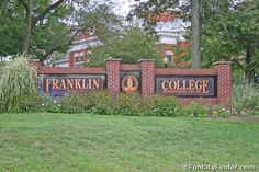 the sign for franklin college in front of some trees