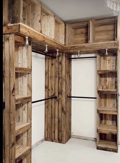 an empty room with wooden shelves and shelving unit in it's center area