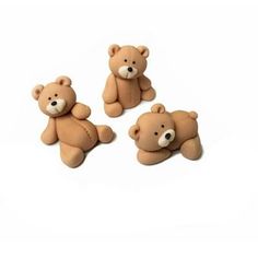 three brown teddy bears sitting next to each other