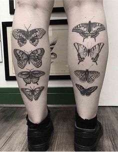 a woman's legs with butterfly tattoos on their thighs, both in black and white