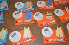 several pieces of paper with clothes on them and some candy wrappers in the middle