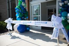 balloons and streamers are tied to the front entrance of a medical building for an event