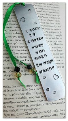 a bookmark with writing on it that says, a book is a dream that you hold in your hands