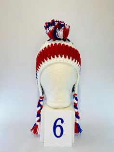 #1 LET'S GO BUFFALO!  Looking to level up your tailgating swag??? This is a one of a kind handmade (crochet) Buffalo football mohawk winter hat! It is made with doubled thick yarn to keep you warm from the pregame tailgate through the post-game VICTORY party! These hats are super cozy to protect you from the whipping winds and cold temps all football season.  Each hat is slightly different because they are all handmade. Each hat is made close to 22 inches in diameter around the largest part of my forehead. The band is crocheted to have some give to it, like elastic to allow each hat to fit multiple head sizes.    Please note these are custom made and I only have the number listed in stock. This hat is made with Red Glitter Yarn. Crochet Buffalo, Glitter Yarn, Buffalo Football, Crochet Unique, Thick Yarn, Red Glitter, Football Season, Winter Hat, Handmade Crochet