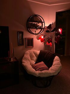 a dog bed in the corner of a living room with lights on and decorations around it