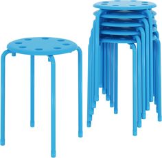 blue stools and tables stacked on top of each other with holes in the middle