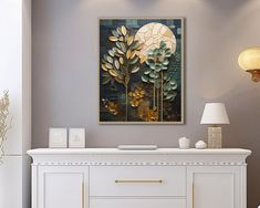 a painting on the wall above a white dresser in a room with grey walls and gold accents