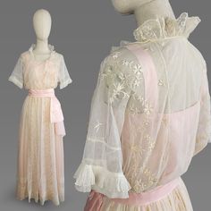 ~1910s Edwardian pale pink taffeta dress with embroidered fine cotton net overdress ~Short  sleeves are trimmed with fagoting and a ruffle  ~Bodice thoroughly embroidered with floral motif with just-netting center panel which is trimmed with fagoting and folded-over netting ~Pale pink taffeta sash is gathered and has flounce at left hip  ~Embroidery continues down center of skirt  ~Center panel is trimmed with net ruffle that wraps around neckline and continues down to waistline ~Back neckline r 1907 Fashion, 1910s Dress, Edwardian Wedding Dress, Edwardian Gowns, Pink Academia, Edwardian Wedding, 1910s Fashion, Edwardian Dress, Lawn Dress