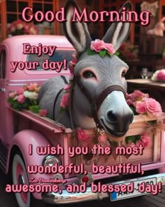 a donkey in the back of a pink truck with flowers on it's head