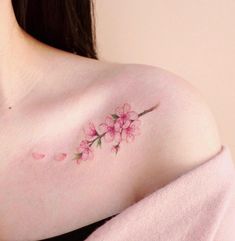 a woman's breast with pink flowers on it