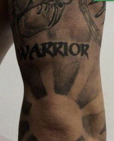 a tattooed arm with the word warrior on it's chest and an arrow in the middle