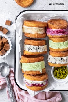 a tray filled with donuts covered in frosting and toppings on top of each other