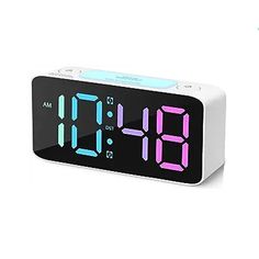 an alarm clock is shown with the time displayed on it's display and features multiple colors