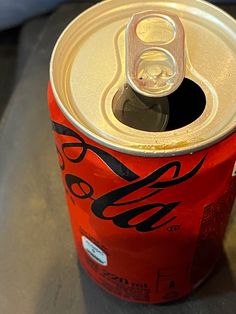 a can of soda sitting on top of a table